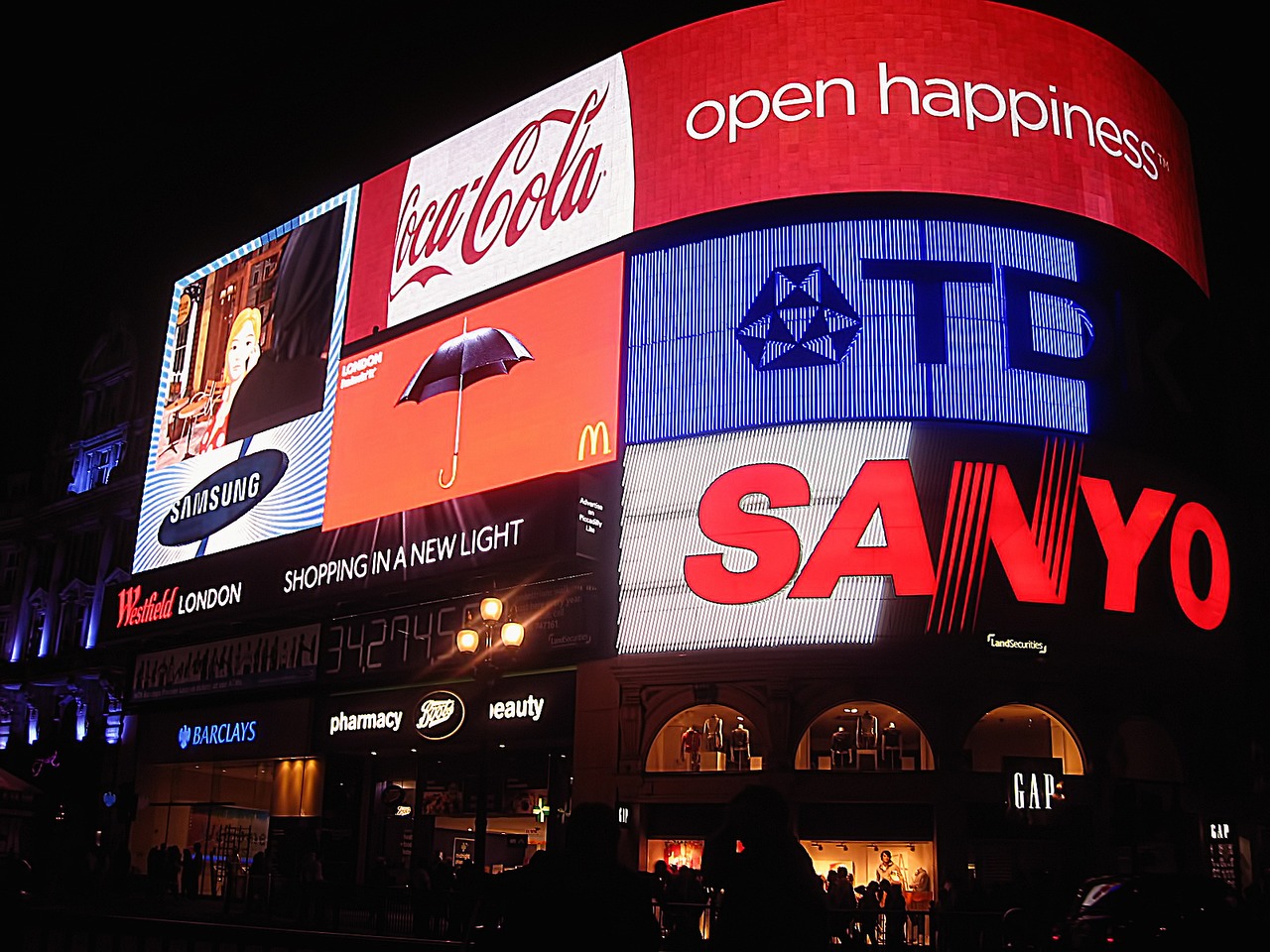 Curved digital ad screens on a landmark corner